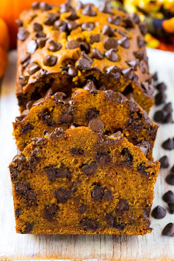 Pumpkin Chocolate Chip Bread Recipe | Pumpkin Bread | Chocolate Pumpkin Bread #pumpkin #bread #fall #chocolate #baking #dessert #uzhal Sliced pumpkin chocolate chip bread on a serving board.