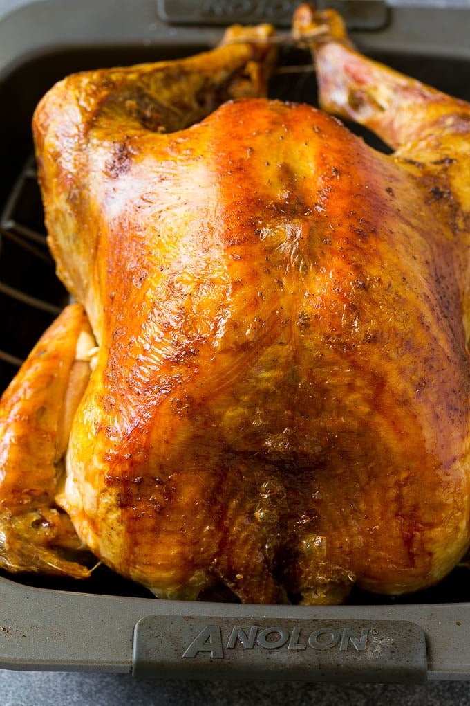 Roast Turkey Recipe | Thanksgiving Turkey | Holiday Turkey | Baked Turkey #turkey #thanksgiving #christmas #dinner #glutenfree #uzhal A roasted turkey in a baking pan.