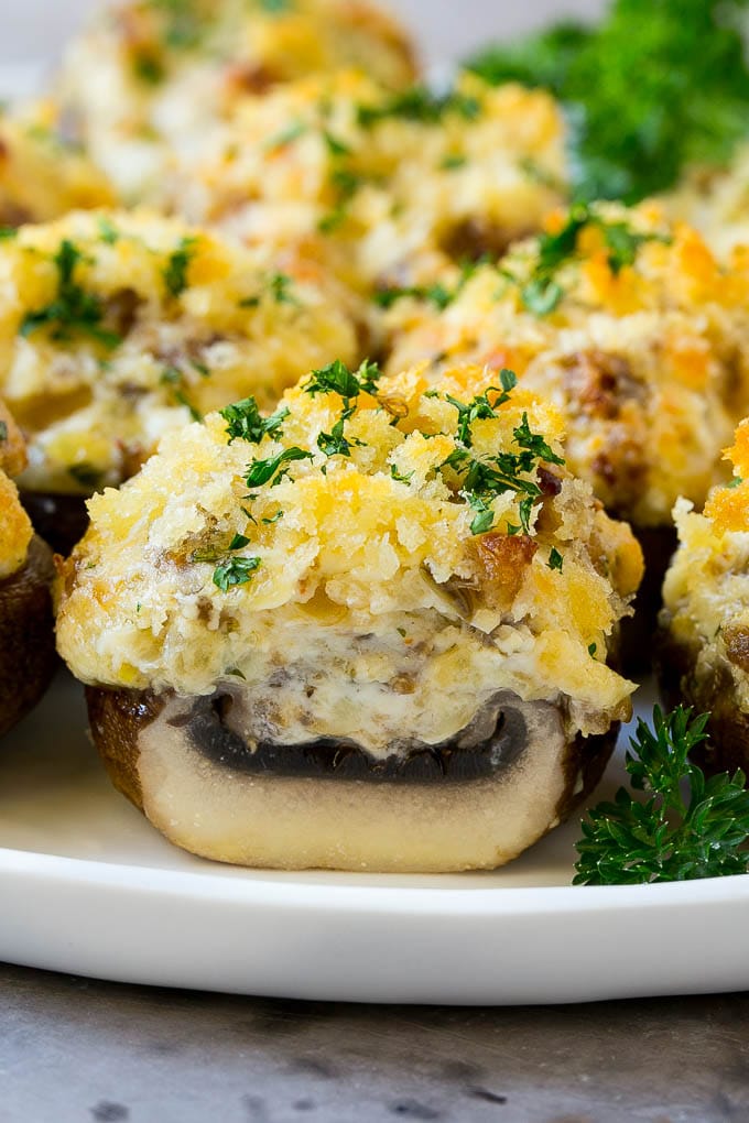Sausage Stuffed Mushrooms Recipe | Stuffed Mushrooms | Mushroom Appetizer #mushrooms #sausage #appetizer #lowcarb #keto #uzhal A cross section of a sausage stuffed mushroom on a serving platter.