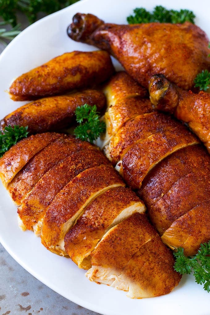 Smoked Chicken Recipe | Whole Smoked Chicken | BBQ Chicken #chicken #smoker #BBQ #dinner #uzhal #glutenfree #lowcarb Carved smoked chicken including drumsticks, wings and chicken breasts on a serving platter.