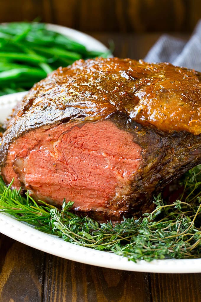 Smoked Prime Rib Recipe | Easy Prime Rib | Smoked Beef | Holiday Prime Rib #primerib #beef #smoker #dinner #uzhal #christmas #thanksgiving #lowcarb #keto A smoked prime rib roast cooked to medium rare on a serving platter.