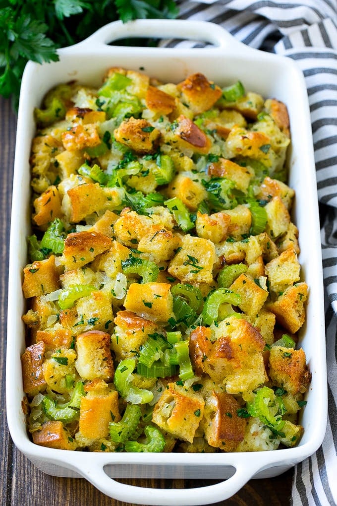 Turkey Stuffing Recipe | Thanksgiving Stuffing | Classic Stuffing #thanksgiving #stuffing #sidedish #fall #uzhal Baked turkey stuffing in a dish topped with fresh parsley.