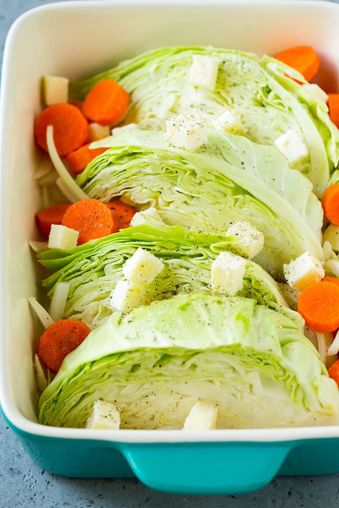 Braised Cabbage Recipe | Easy Cabbage Recipe #cabbage #lowcarb #keto #carrots #veggies #vegetarian #dinner #uzhal Cabbage, carrots, onions, pieces of butter and seasonings in a baking dish.
