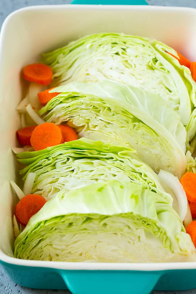 Braised Cabbage Recipe | Easy Cabbage Recipe #cabbage #lowcarb #keto #carrots #veggies #vegetarian #dinner #uzhal Wedges of cabbage, sliced carrots and onion in a baking dish.