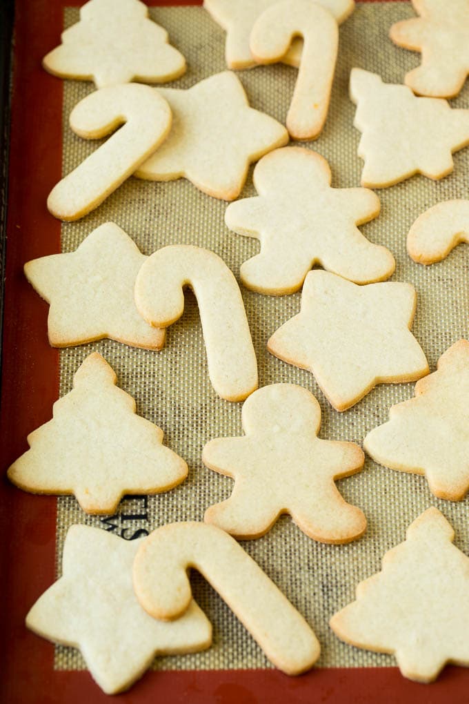 Christmas Sugar Cookies Recipe | Christmas Cookies #cookies #frosting #sprinkles #sugarcookies #christmas #dessert #uzhal Cut out cookies on a sheet pan.