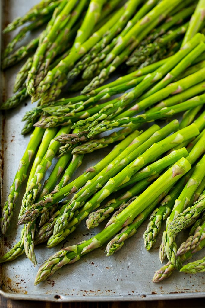 Roasted Asparagus Recipe | Baked Asparagus | Asparagus Side Dish #asparagus #garlic #sidedish #keto #lowcarb #dinner #uzhal Raw asparagus spears on a sheet pan.