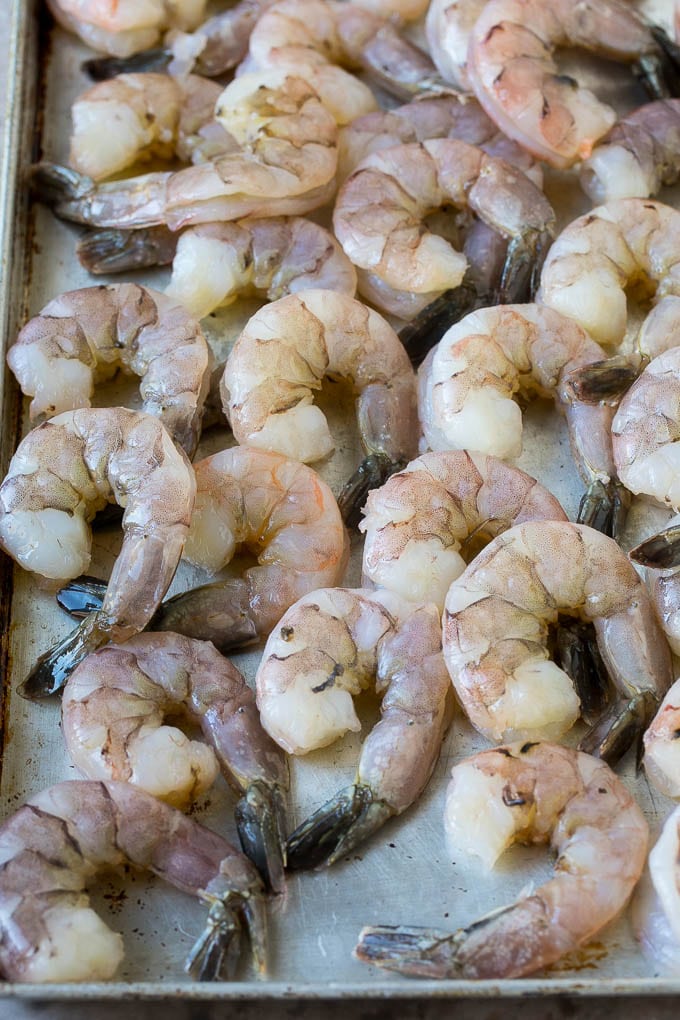 Coconut Shrimp Recipe | Fried Shrimp | Shrimp Appetizer #shrimp #coconut #appetizer #seafood #dinner #uzhal Large raw tail-on shrimp arranged on a sheet pan.