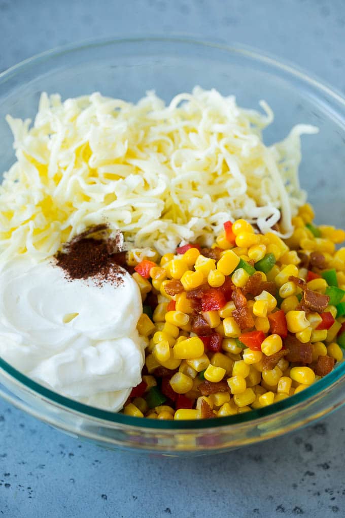 Corn Dip Recipe | Hot Cheese Dip | Bacon Dip #corn #dip #bacon #cheese #appetizer #snack #uzhal Corn, bacon, bell peppers, sour cream and cheese in a mixing bowl.