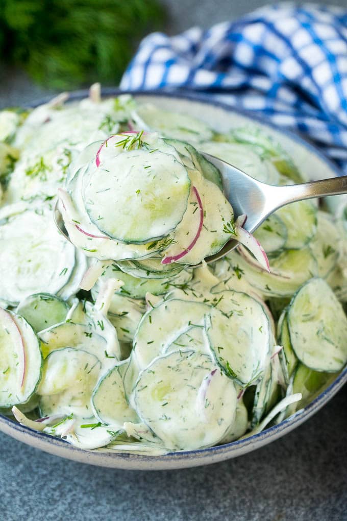 Creamy Cucumber Salad Recipe | German Cucumber Salad | Cucumber Salad #cucumber #salad #dinner #lunch #uzhal #cucumbersalad A spoon serving up a portion of creamy cucumber salad.