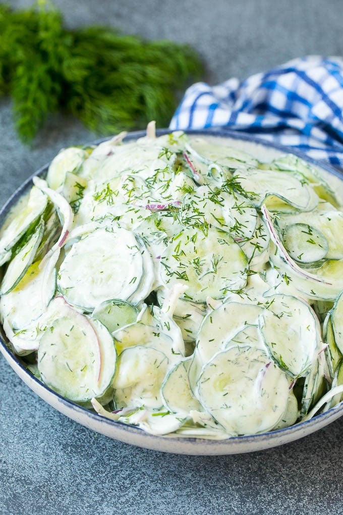 Creamy Cucumber Salad Recipe | German Cucumber Salad | Cucumber Salad #cucumber #salad #dinner #lunch #uzhal #cucumbersalad A serving bowl of creamy cucumber salad topped with fresh dill.