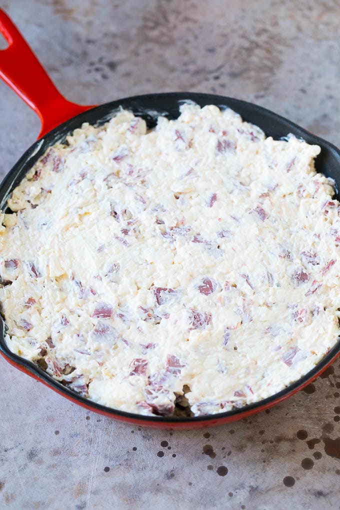 Reuben Dip Recipe | Corned Beef Dip | Cheese Dip #dip #cheese #cornedbeef #appetizer #lowcarb #keto #uzhal Cream cheese, corned beef and other ingredients spread into a skillet for baking.