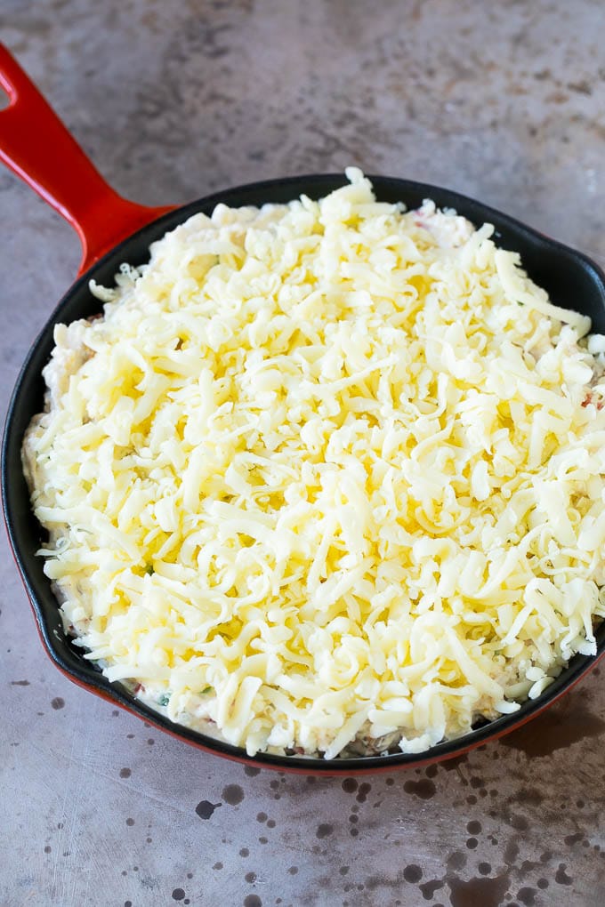 Reuben Dip Recipe | Corned Beef Dip | Cheese Dip #dip #cheese #cornedbeef #appetizer #lowcarb #keto #uzhal A skillet of dip topped with shredded cheese.