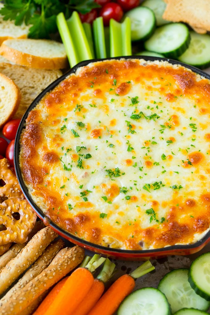 Reuben Dip Recipe | Corned Beef Dip | Cheese Dip #dip #cheese #cornedbeef #appetizer #lowcarb #keto #uzhal Baked Reuben dip in a skillet served with crackers and vegetables.