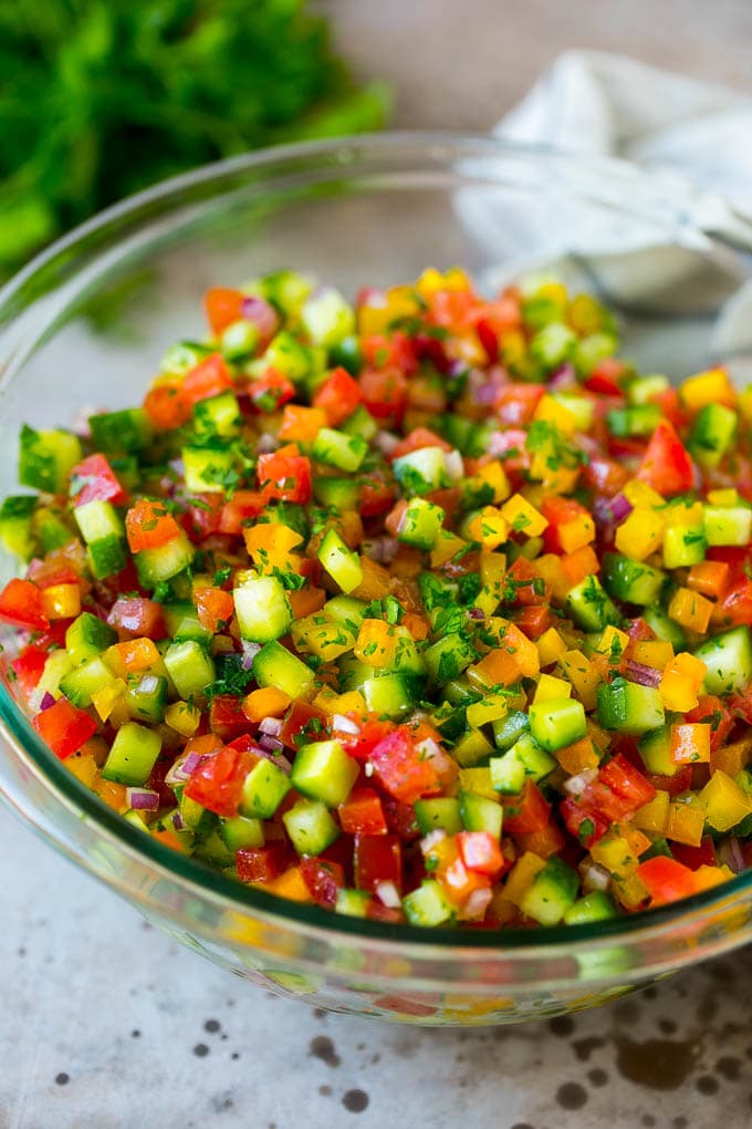 Israeli Salad Recipe | Cucumber Salad | Tomato Salad | Chopped Salad #salad #cleaneating #healthy #glutenfree #lowcarb #keto #sidedish #lunch #uzhal Israeli salad with cucumbers and tomatoes in a serving bowl.