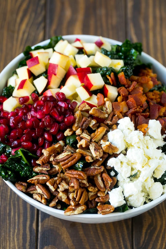 Apple Kale Salad Recipe | Kale Recipe | Fall Salad #kale #apples #bacon #salad #feta #dinner #lunch #uzhal Kale salad topped with apples, bacon, pecans, pomegranate and feta cheese.