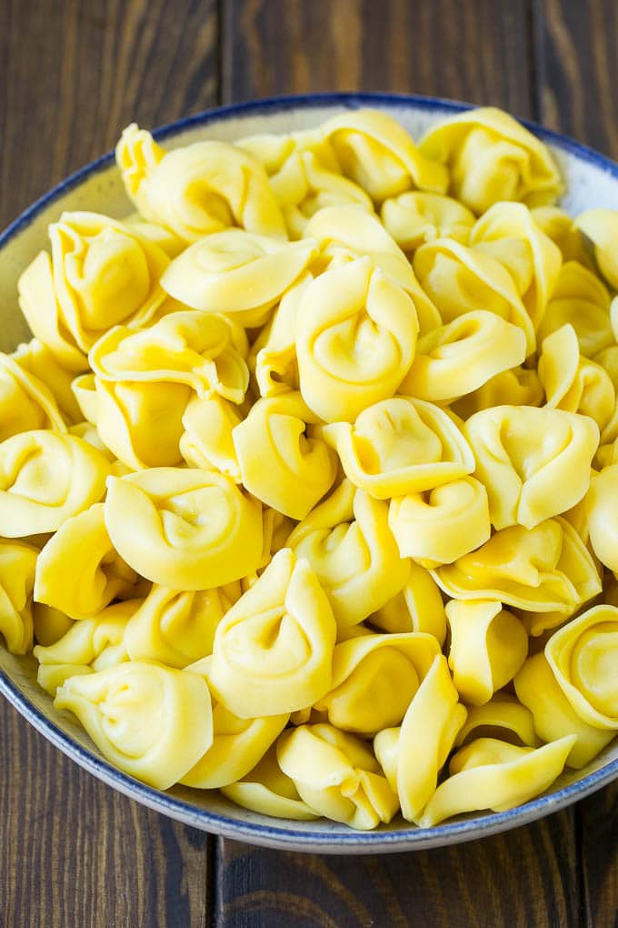 Greek Tortellini Salad Recipe | Pasta Salad | Tortellini Salad | Greek Salad #greek #tortellini #pasta #salad #cucumbers #olives #dinner #uzhal A bowl of cooked cheese tortellini.