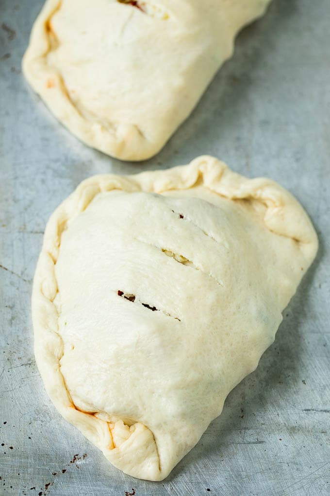 Calzone Recipe | Pizza Pockets #pizza #calzone #pepperoni #sausage #peppers #dinner #uzhal #cheese Unbaked calzones ready to go into the oven.