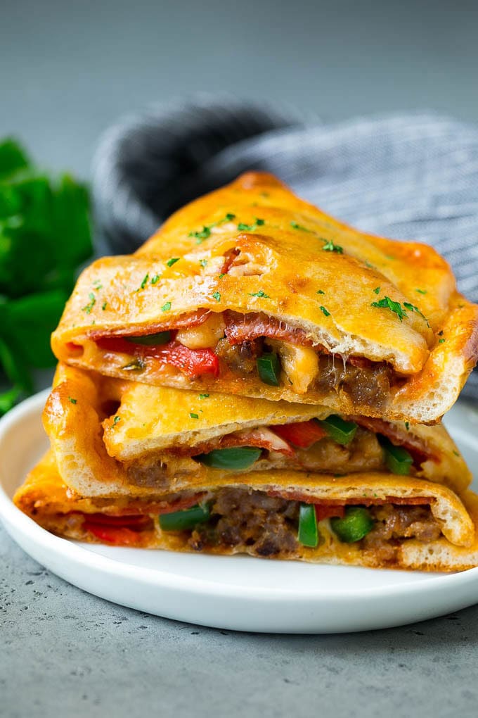 Calzone Recipe | Pizza Pockets #pizza #calzone #pepperoni #sausage #peppers #dinner #uzhal #cheese Calzone halves stuffed with sausage, peppers, cheese and pepperoni.
