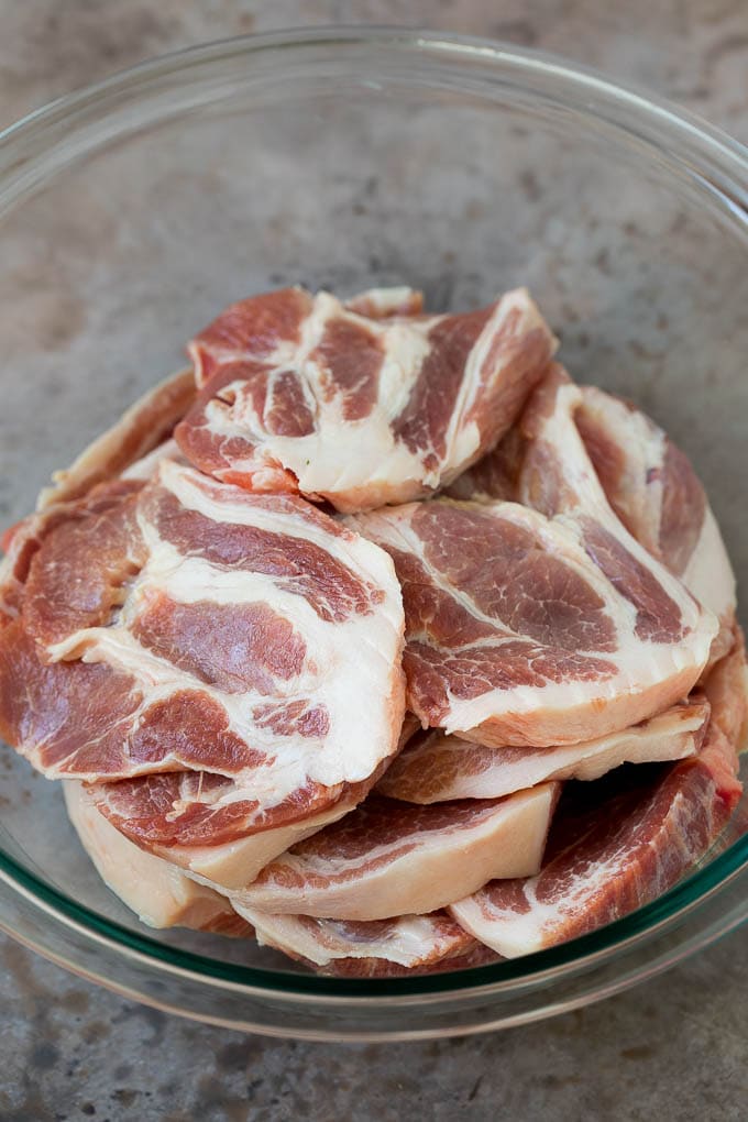 Tacos al Pastor Recipe | Pork Tacos | Mexican Tacos #tacos #pork #pineapple #grilling #tacotuesday #dinner #uzhal Sliced pork shoulder in a bowl.