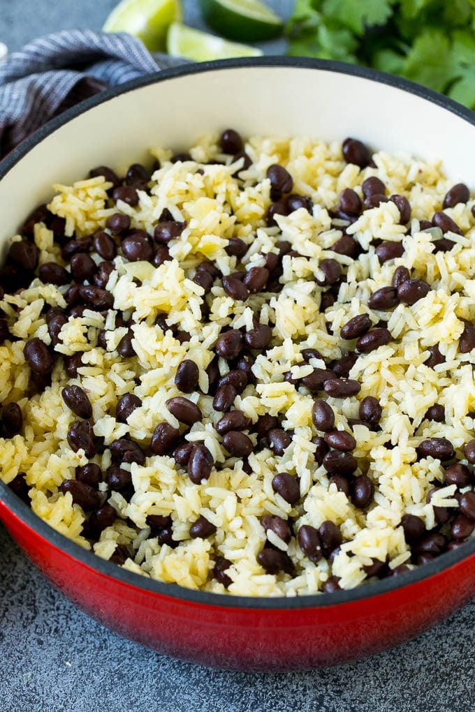 Black Beans and Rice Recipe | Cuban Black Beans | Beans and Rice #beans #rice #blackbeans #sidedish #glutenfree #dinner #uzhal Rice and beans mixed together in a red pot.