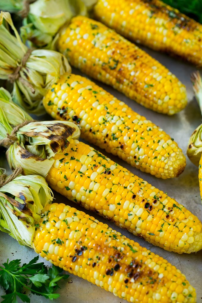 Grilled Corn on the Cob Recipe | Corn Recipe #corn #grilling #summer #sidedish #dinner #uzhal Grilled corn on the cob topped with garlic and herb butter on a sheet pan.