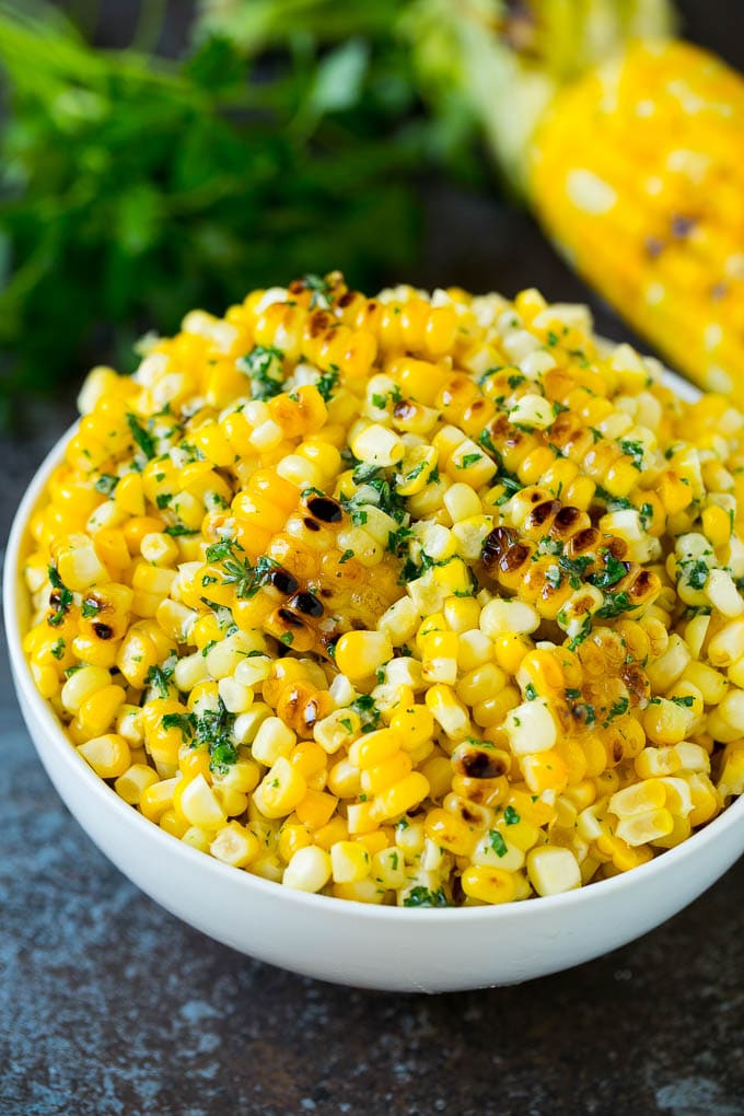 Grilled Corn on the Cob Recipe | Corn Recipe #corn #grilling #summer #sidedish #dinner #uzhal Grilled corn cut off the cob with herb butter in a bowl.
