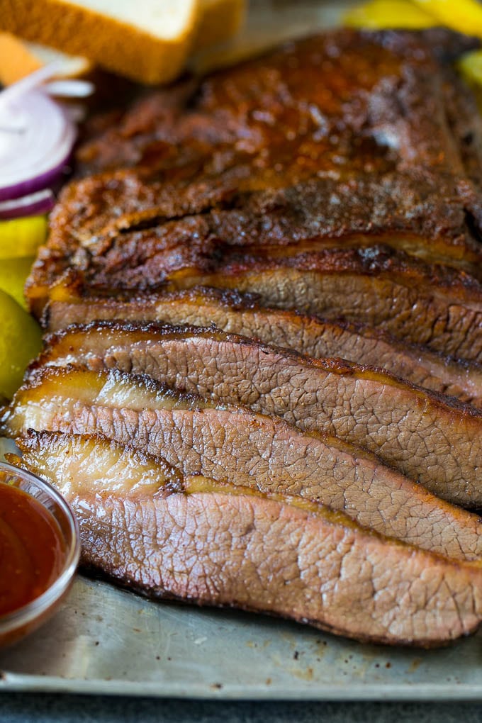 Smoked Brisket Recipe | Beef Brisket | BBQ Beef #brisket #smoker #beef #bbq #dinner #uzhal Sliced smoked brisket with a side of BBQ sauce.