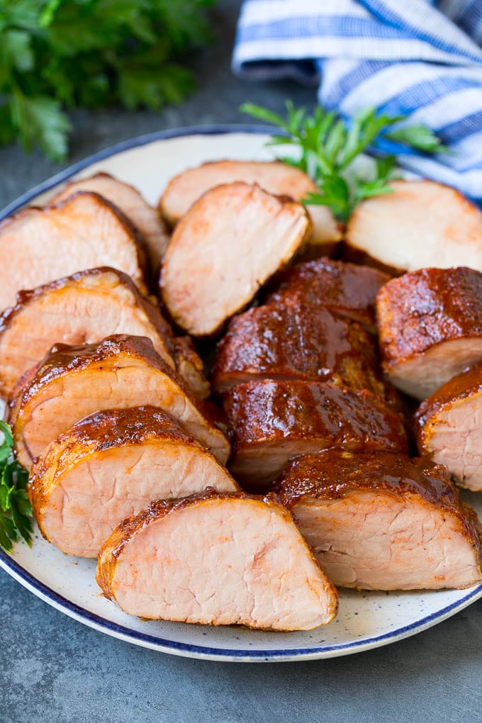Smoked Pork Tenderloin Recipe | Smoked Pork Loin | BBQ Pork #pork #tenderloin #smoker #dinner #uzhal Smoked pork tenderloin sliced on a serving plate.