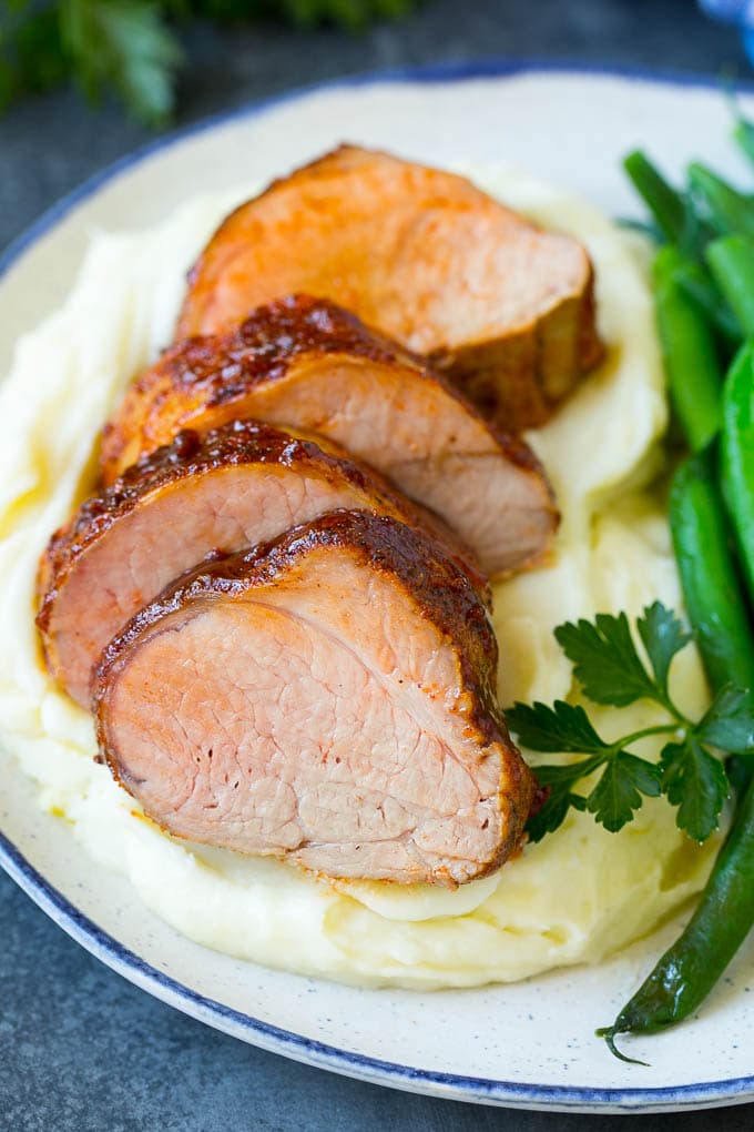 Smoked Pork Tenderloin Recipe | Smoked Pork Loin | BBQ Pork #pork #tenderloin #smoker #dinner #uzhal Sliced smoked pork tenderloin served with mashed potatoes and vegetables.