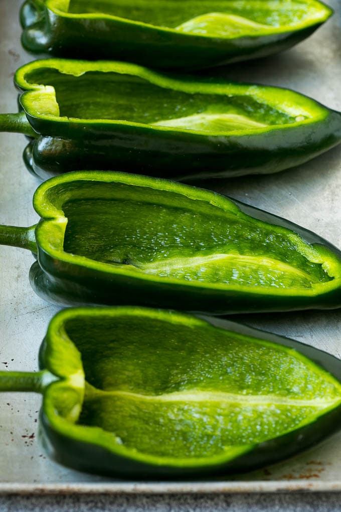Stuffed Poblano Peppers | Stuffed Peppers | Pasilla Peppers #peppers #stuffedpeppers #beef #rice #beans #corn #dinner #uzhal Hollowed out poblano peppers on a pan.