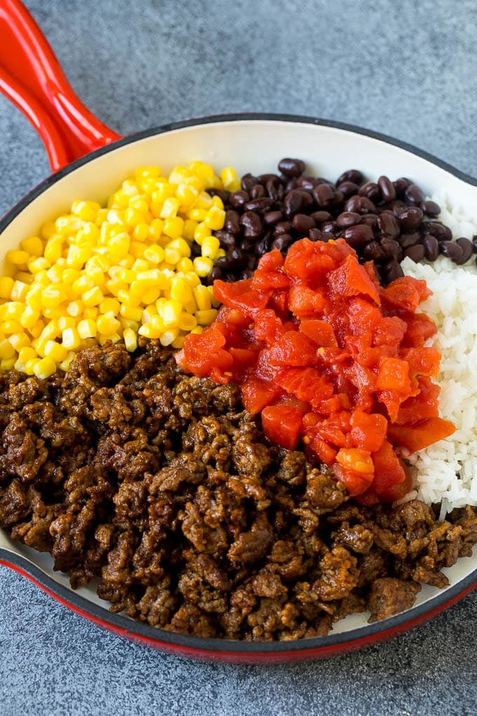 Stuffed Poblano Peppers | Stuffed Peppers | Pasilla Peppers #peppers #stuffedpeppers #beef #rice #beans #corn #dinner #uzhal A skillet filled with ground beef, rice, tomatoes, beans and corn.