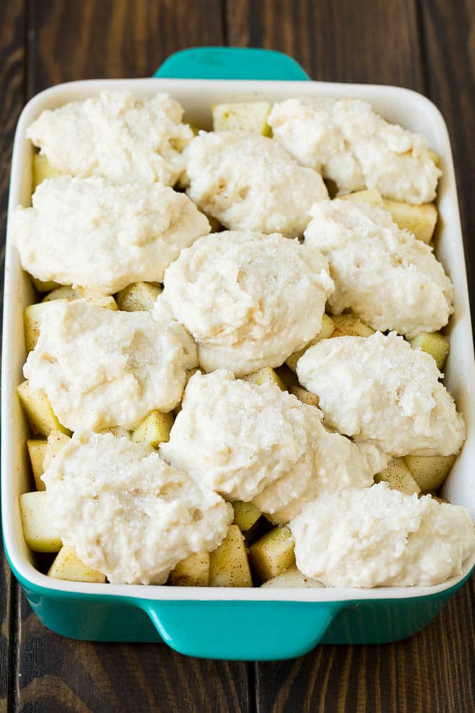 Apple Cobbler Recipe | Apple Dessert #apples #cobbler #dessert #baking #fall #uzhal Fruit in a baking dish with dough over the top.