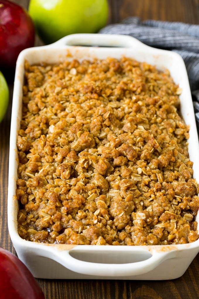 A baked apple crisp with an oatmeal and walnut topping.