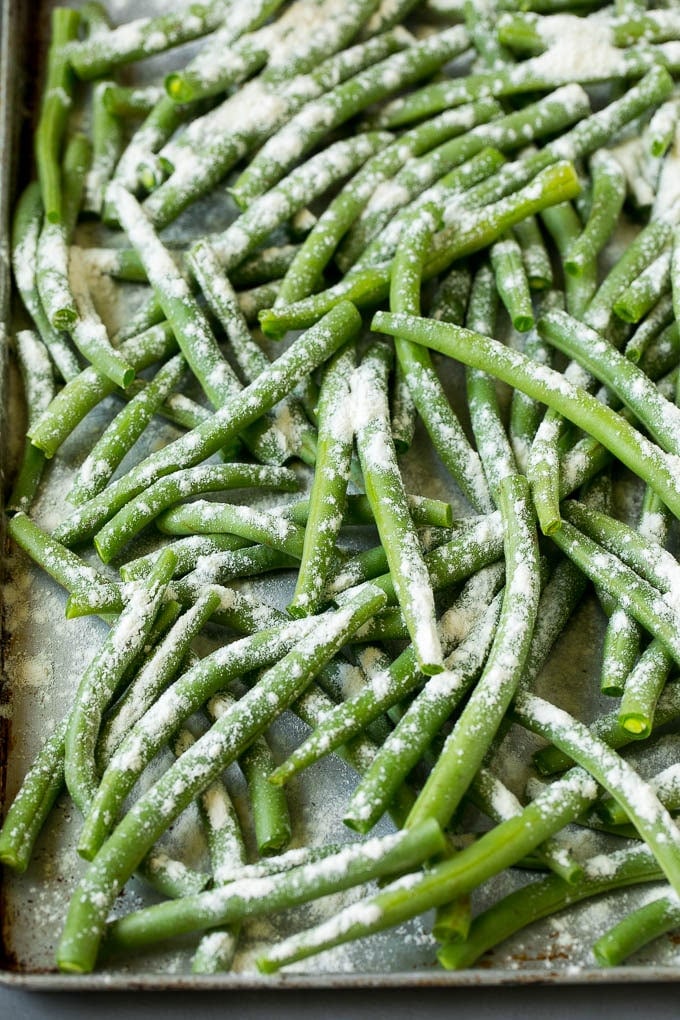 Fried Green Beans Recipe | Green Beans #greenbeans #appetizer #snack #uzhal Bean coated in flour on a pan.