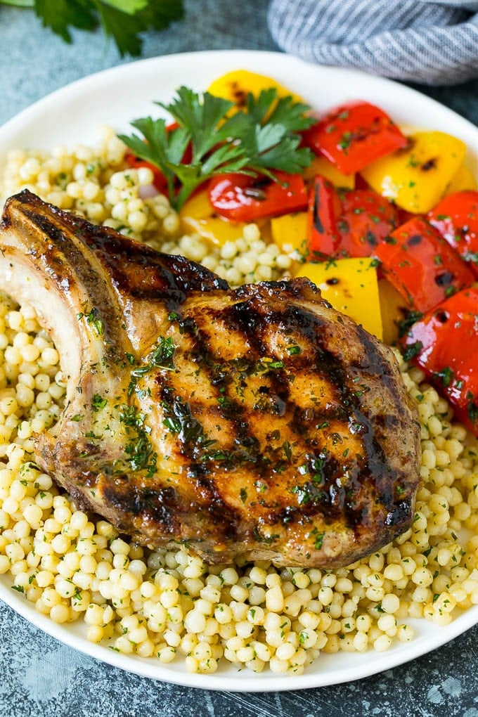 Grilled Pork Chops | Pork Chop Marinade #porkchops #grilling #pork #marinade #dinner #uzhal A grilled pork chop served over couscous with bell peppers on the side.