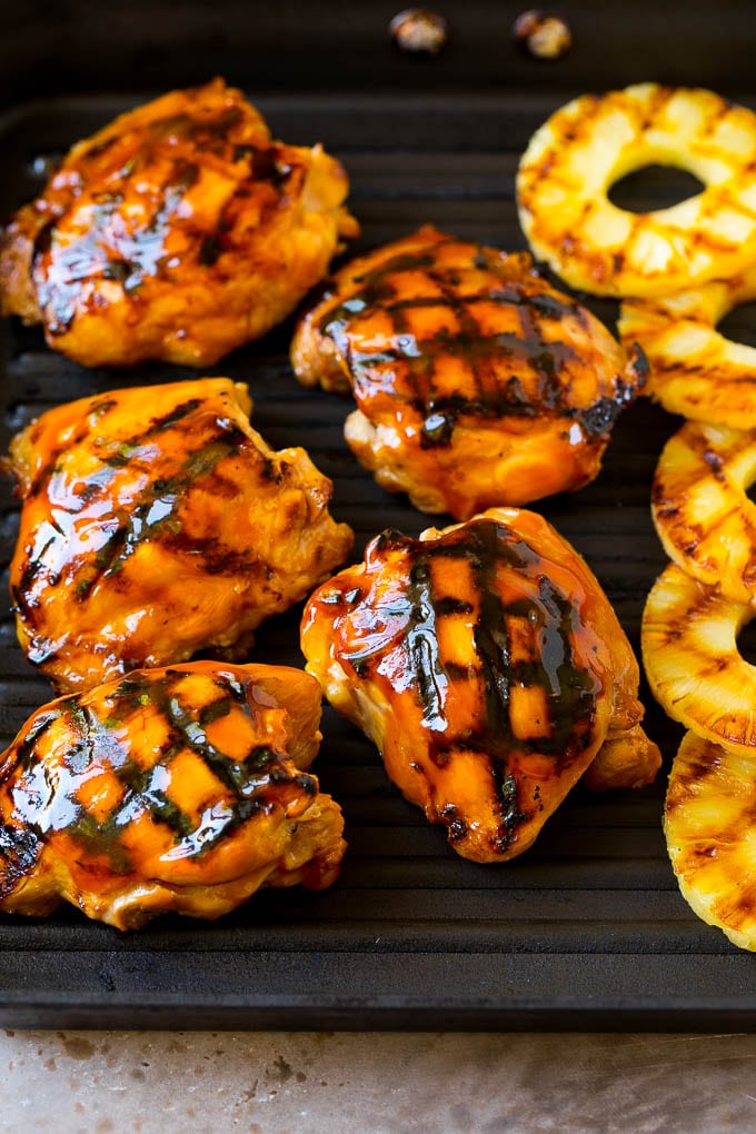 Huli Huli Chicken Recipe | Hawaiian Chicken | Grilled Chicken Thighs #chicken #pineapple #grilling #dinner #uzhal Poultry and pineapple slices on a grill pan.