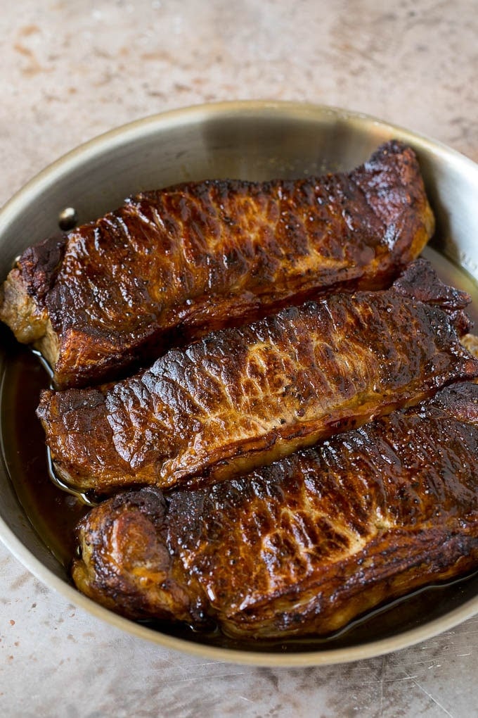 Surf and Turf Recipe | Seared Steak #steak #shrimp #keto #lowcarb #dinner #uzhal Seared strip steaks in a skillet.