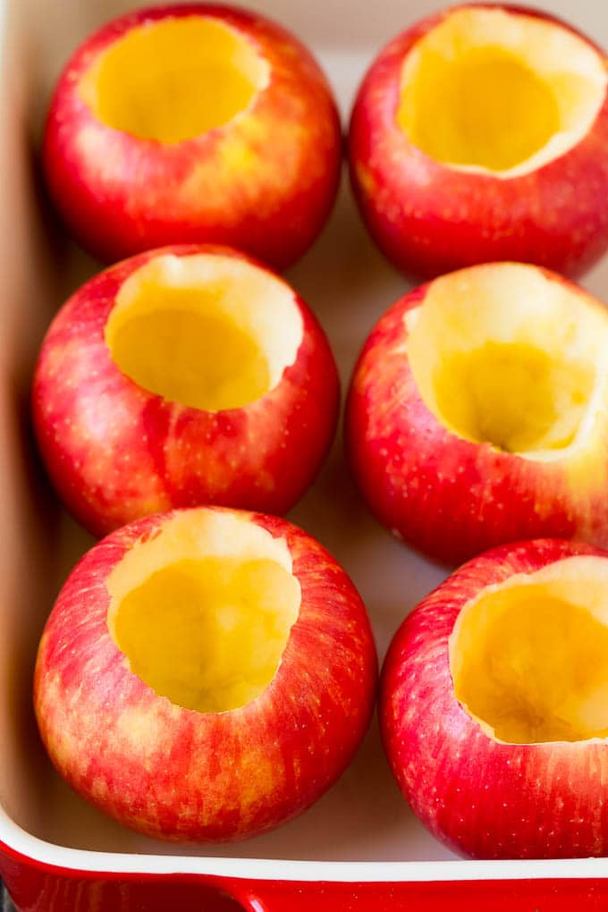 Baked Apples | Stuffed Apples #apples #fall #dessert #sweettooth #uzhal Hollowed out apples in a baking dish.