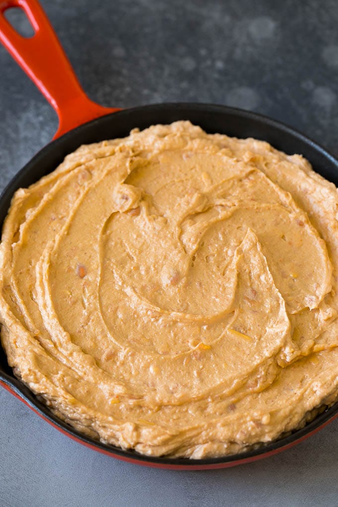 Bean Dip Recipe | Mexican Dip #dip #appetizer #mexicanfood #beans #cheese #uzhal Refried frijoles mixed with cream cheese, sour cream and seasonings in a skillet.