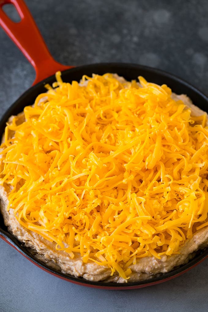 Bean Dip Recipe | Mexican Dip #dip #appetizer #mexicanfood #beans #cheese #uzhal The base topped with freshly shredded cheese.
