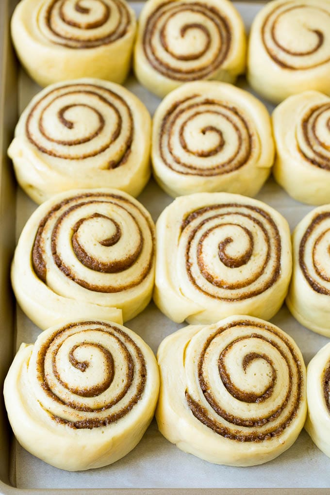 Cinnamon Rolls Recipe | Cinnamon Buns #cinnamon #rolls #pastry #breakfast #brunch #sweets #uzhal #baking #bread Rolls of dough and filling rising on a sheet pan.