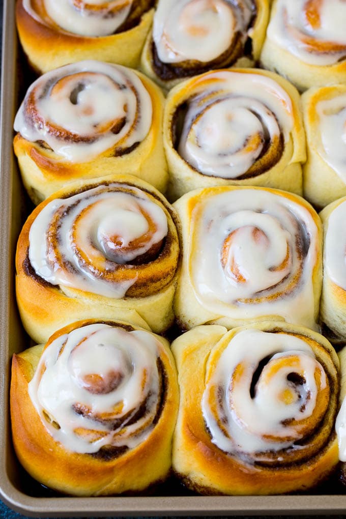 Cinnamon Rolls Recipe | Cinnamon Buns #cinnamon #rolls #pastry #breakfast #brunch #sweets #uzhal #baking #bread A tray of frosted cinnamon rolls.