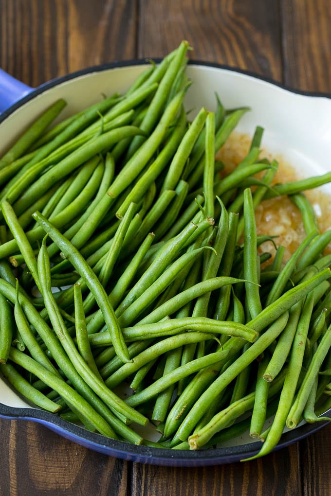 Green Beans with Bacon Recipe | Bacon Green Beans #bacon #greenbeans #sidedish #thanksgiving #veggies #dinner #uzhal Beans in a pan with onions.