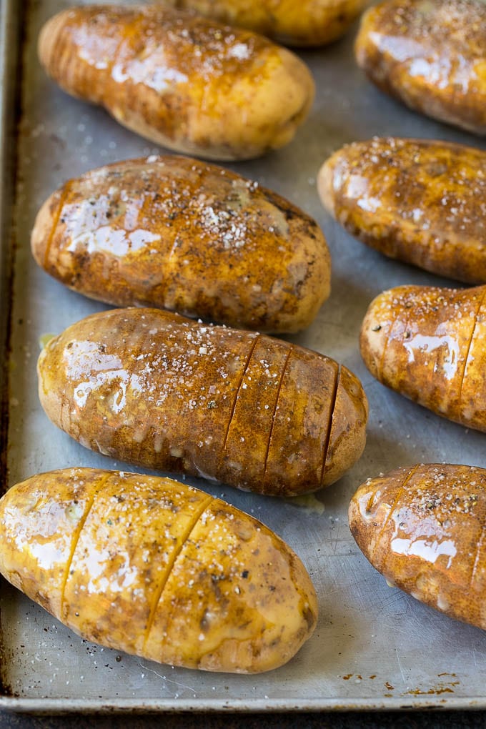 Hasselback Potatoes Recipe #potatoes #bacon #sidedish #cheese #dinner #uzhal Potatoes on a sheet pan coated in olive oil and butter.