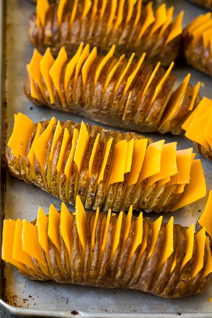 Hasselback Potatoes Recipe #potatoes #bacon #sidedish #cheese #dinner #uzhal Thinly sliced potatoes with slices of cheese in between the cuts.