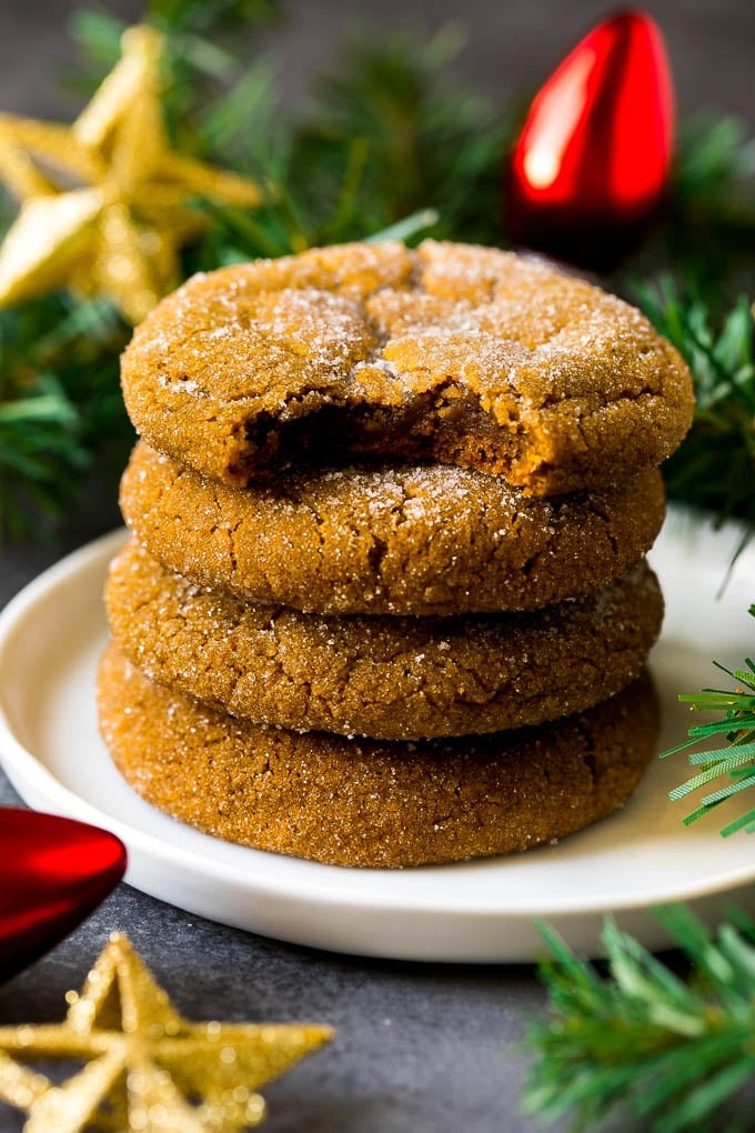 Molasses Cookies Recipe | Spice Cookies #cookies #baking #christmas #dessert #uzhal A stack of molasses cookies with a bite taken out of one.
