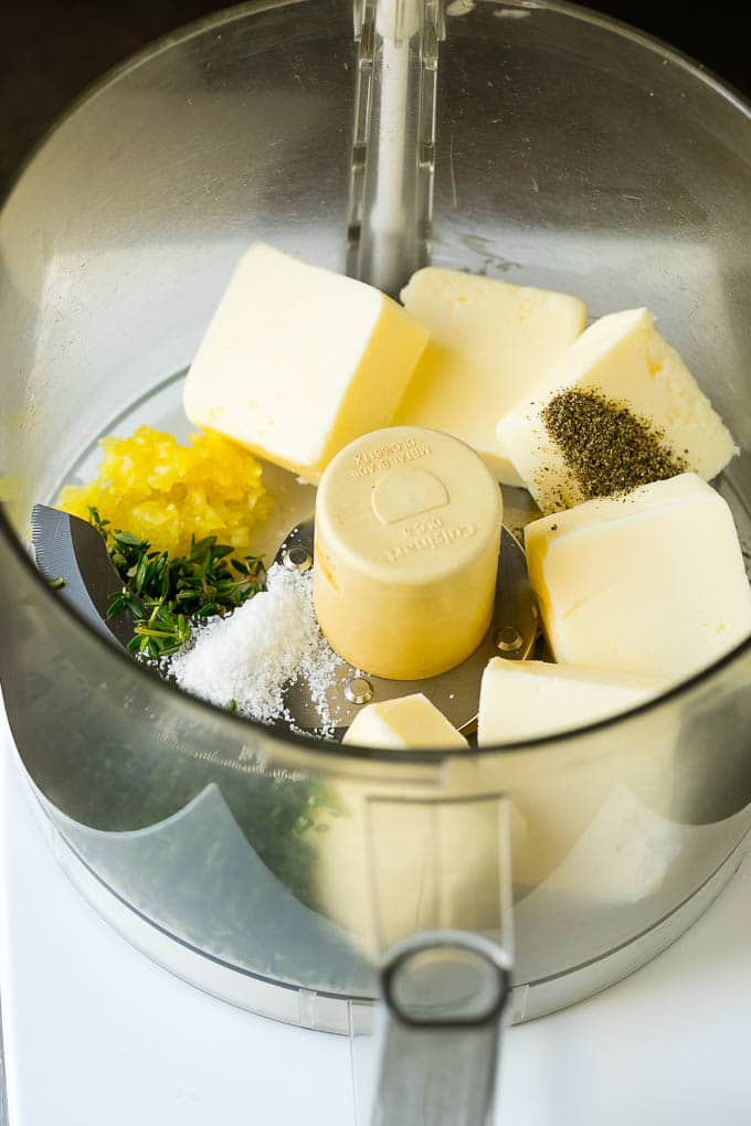 Butter, garlic herbs and seasonings in a food processor.