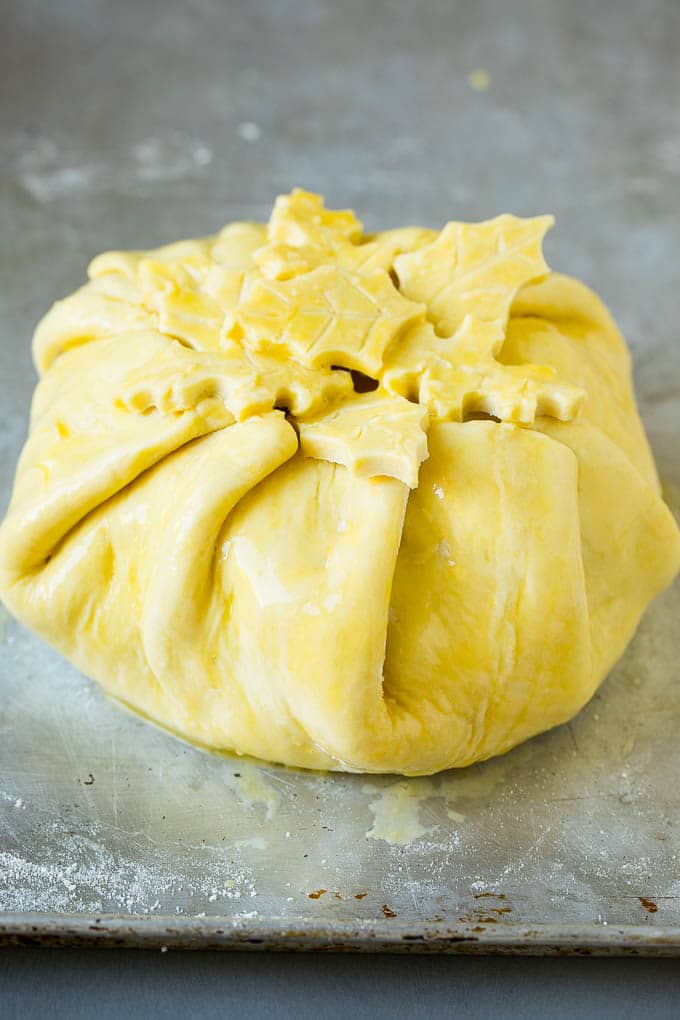 Baked Brie Recipe | Pastry Wrapped Brie #brie #cheese #appetizer #pecans #raspberries #uzhal Cheese wrapped in puff pastry and topped with egg wash.