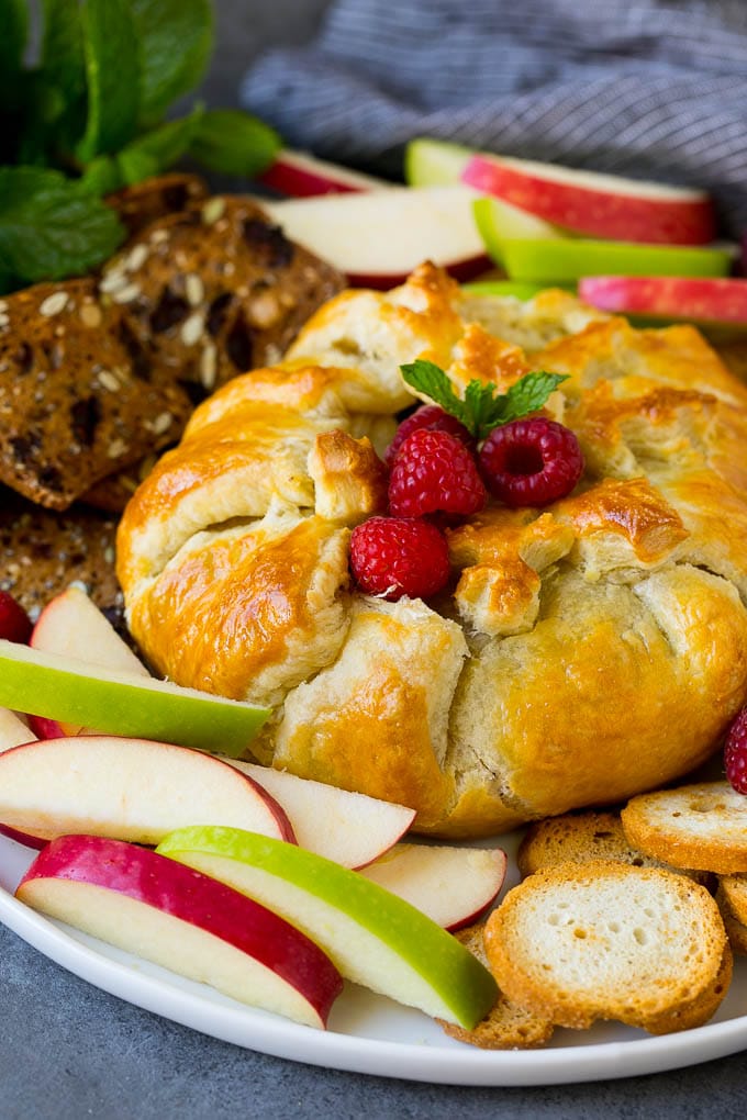 Baked Brie Recipe | Pastry Wrapped Brie #brie #cheese #appetizer #pecans #raspberries #uzhal Brie wrapped in puff pastry, served with apples and crackers.