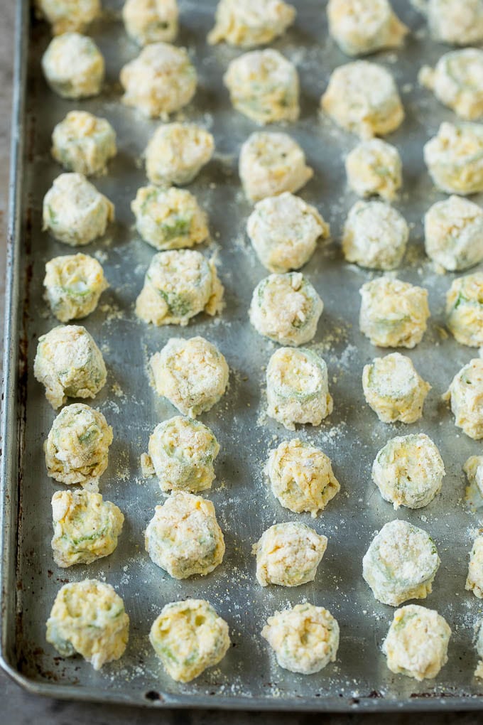 Fried Okra Recipe #okra #appetizer #sidedish #uzhal Breaded okra slices on a sheet pan.